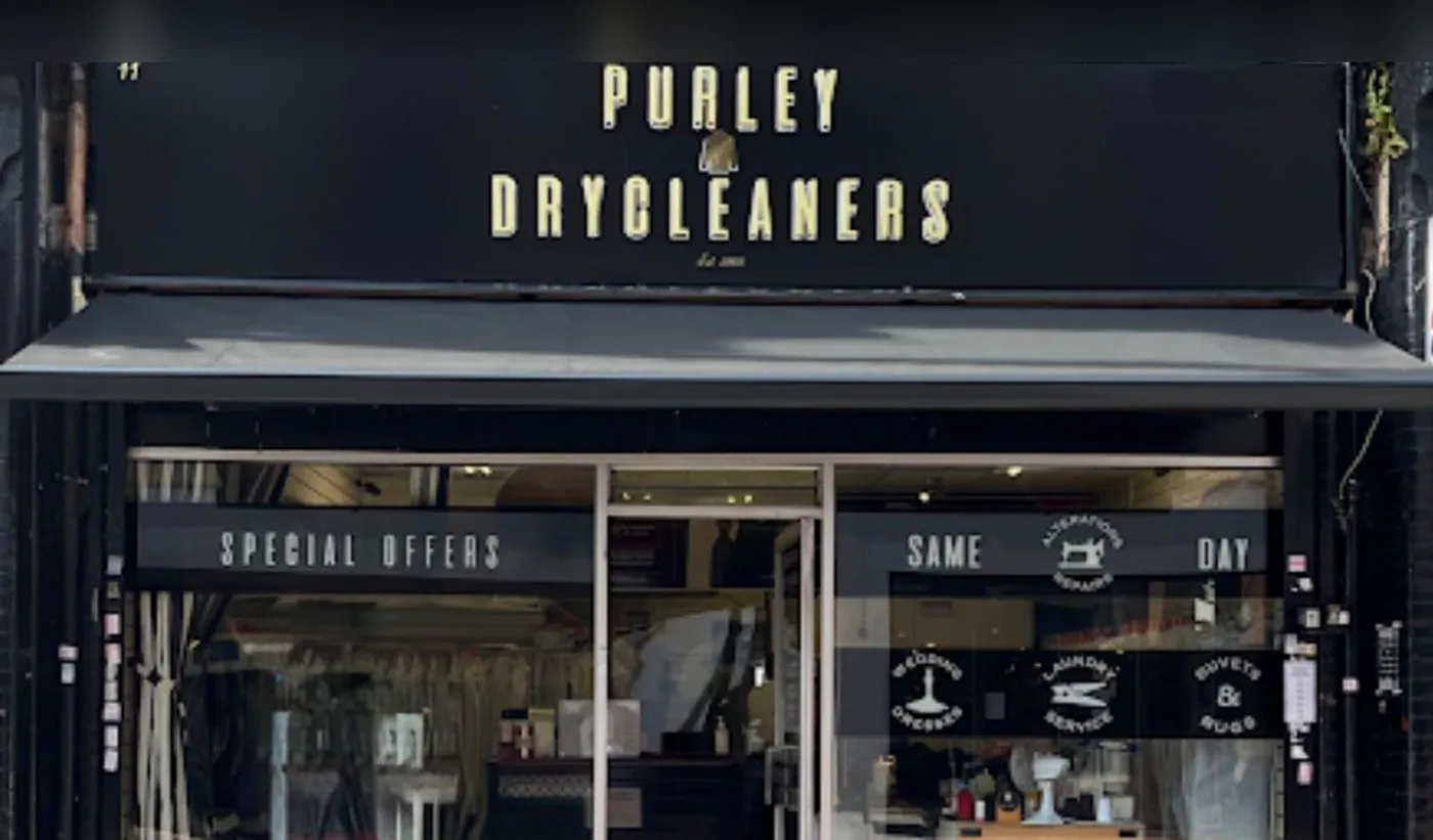 The black and gold shopfront of Purley Dry Cleaners at 11 High Street