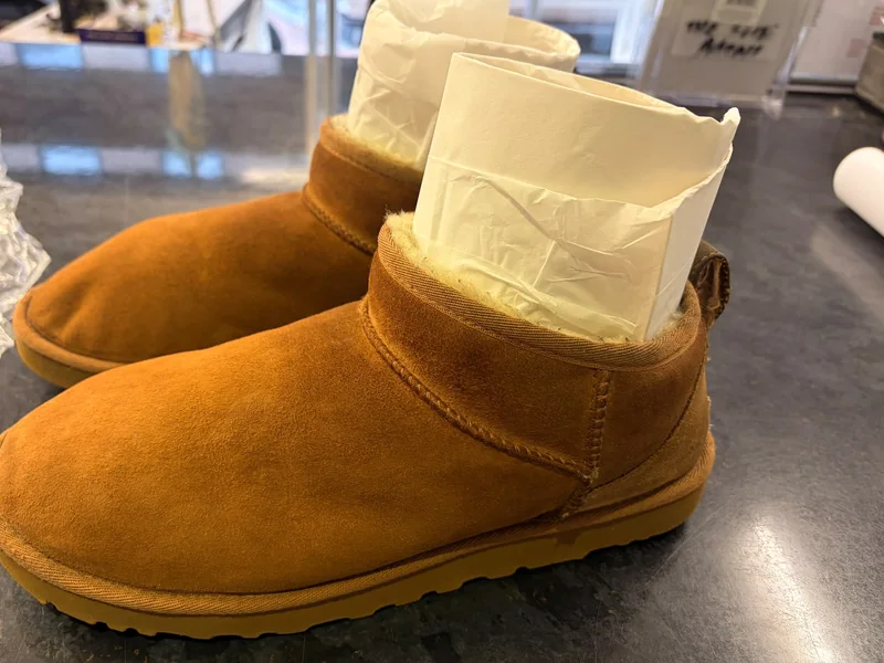 The same boots after cleaning, with the colour restored and the sole clean